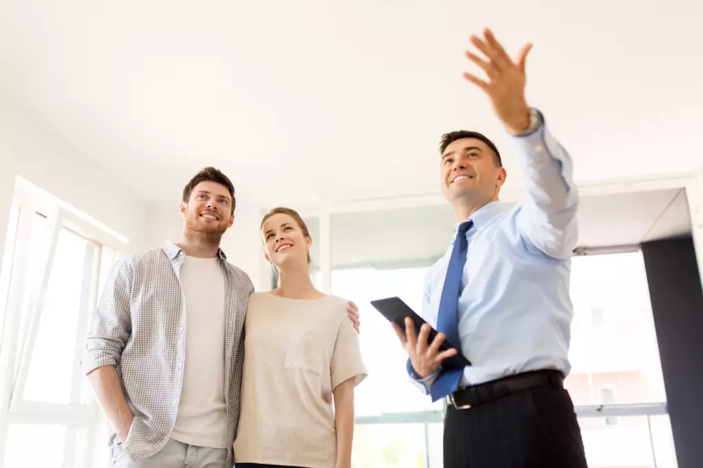 Couple and realtor with tablet